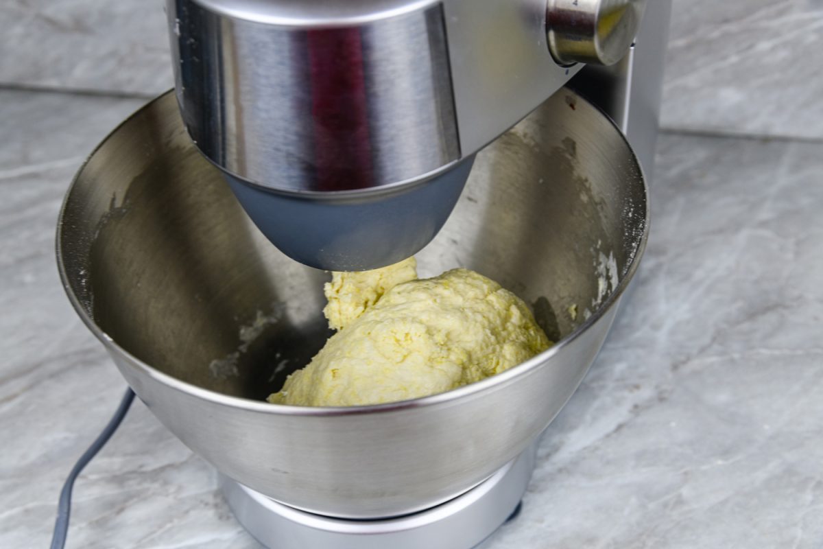 Kneading dough in a modern food processor on a kitchen table
