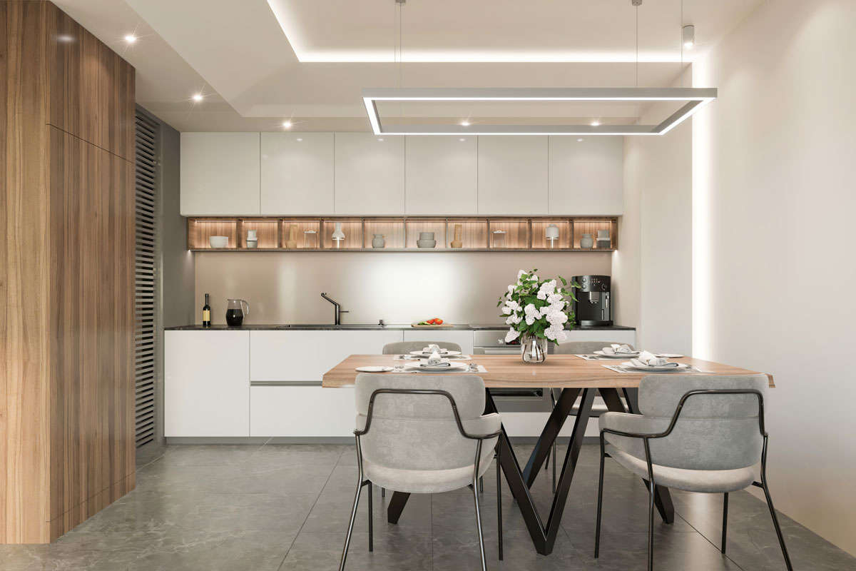 Luxurious white modern kitchen with dangling lamps, gray flooring and a small dining table