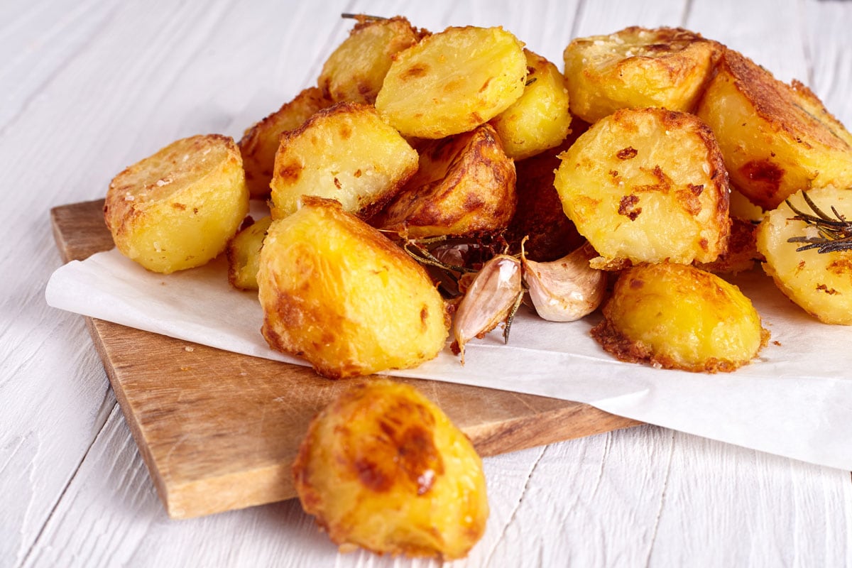 Roast potatoes seasoned with salt, garlic and provance herbs on wood