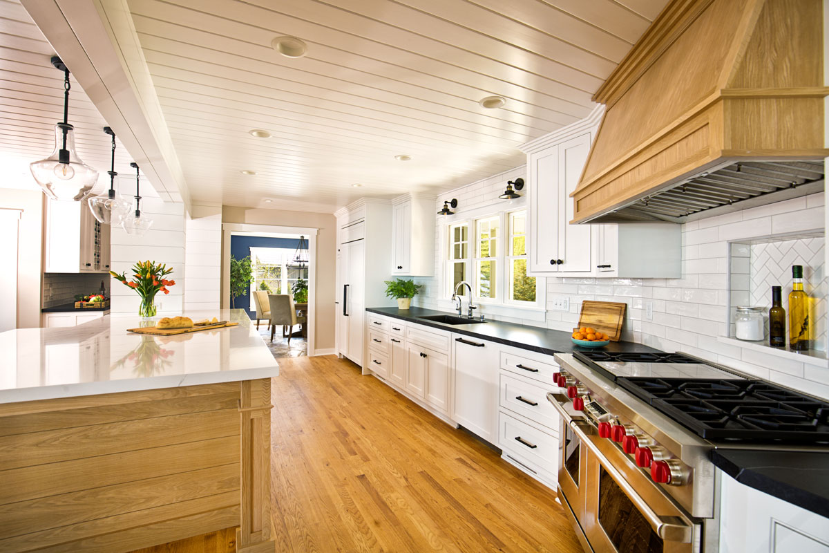 Rustic inspired kitchen with laminated flooring, white countertops and white metal roofing