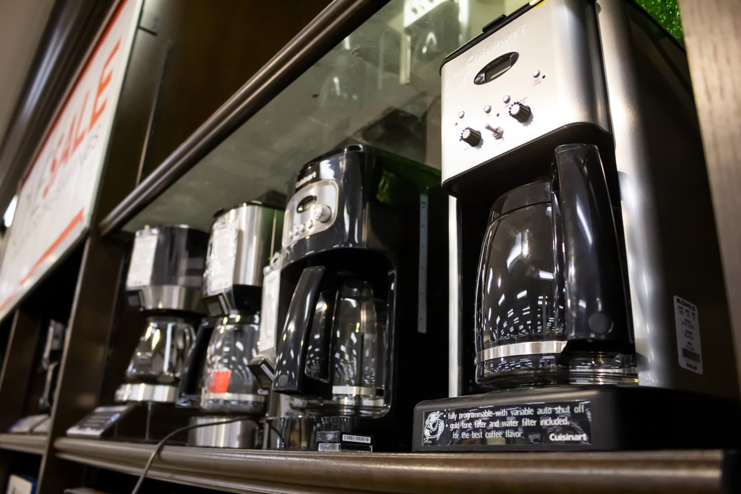 Several Cuisinart coffee maker machines on display at a local department store.