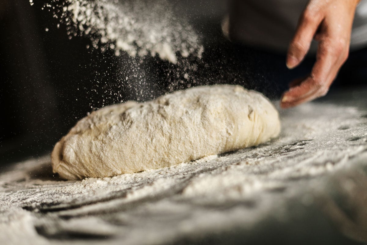 Spraying flour on the dough