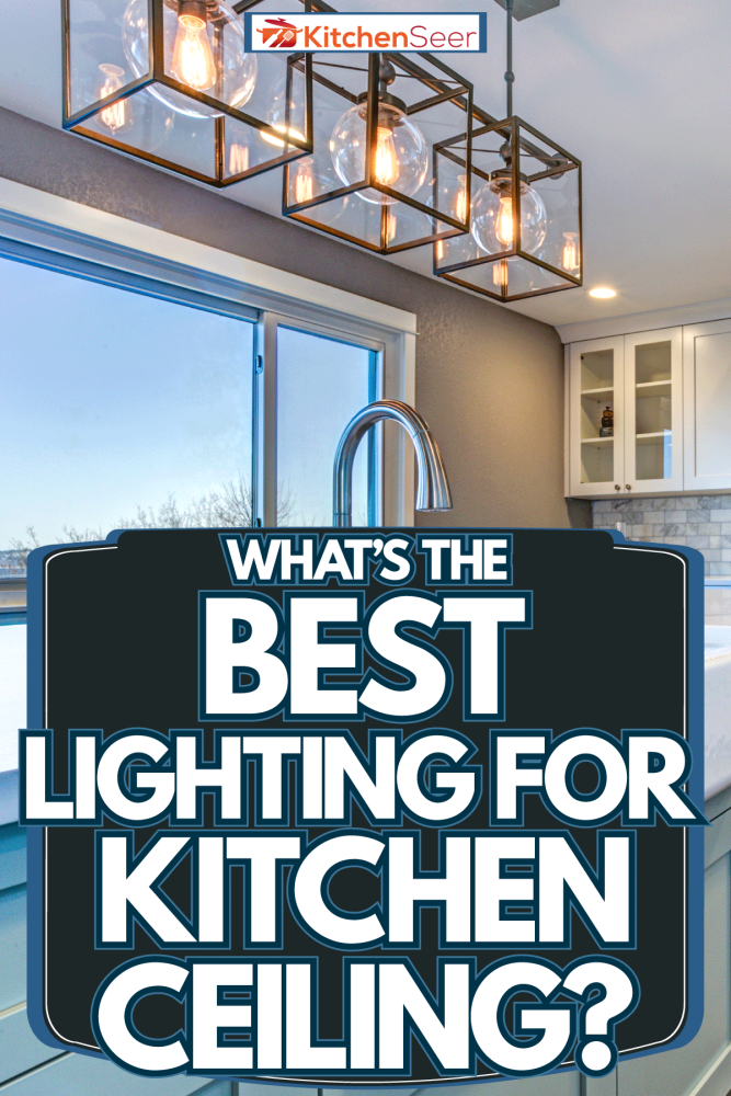 Luxurious interior of a house with wooden flooring, square dangling lamps and white countertops with a scenic view of a lake, What's The Best Lighting For Kitchen Ceiling?