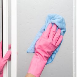 Woman cleaning the inside wall of a fridge, How To Clean Mold From Fridge [Inc. Seal]