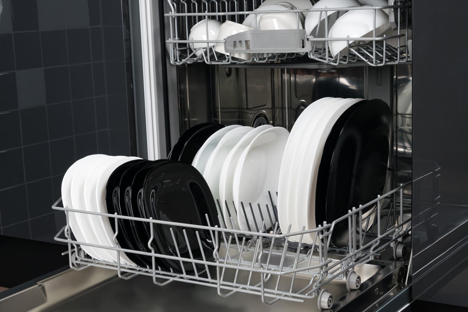 black and white plates in the dishwasher compartment, close-up