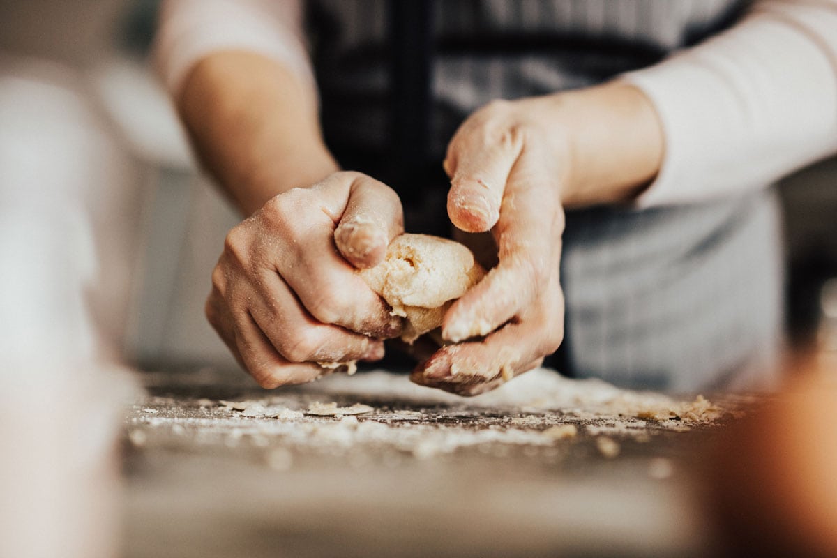 woman's hands kneading dough