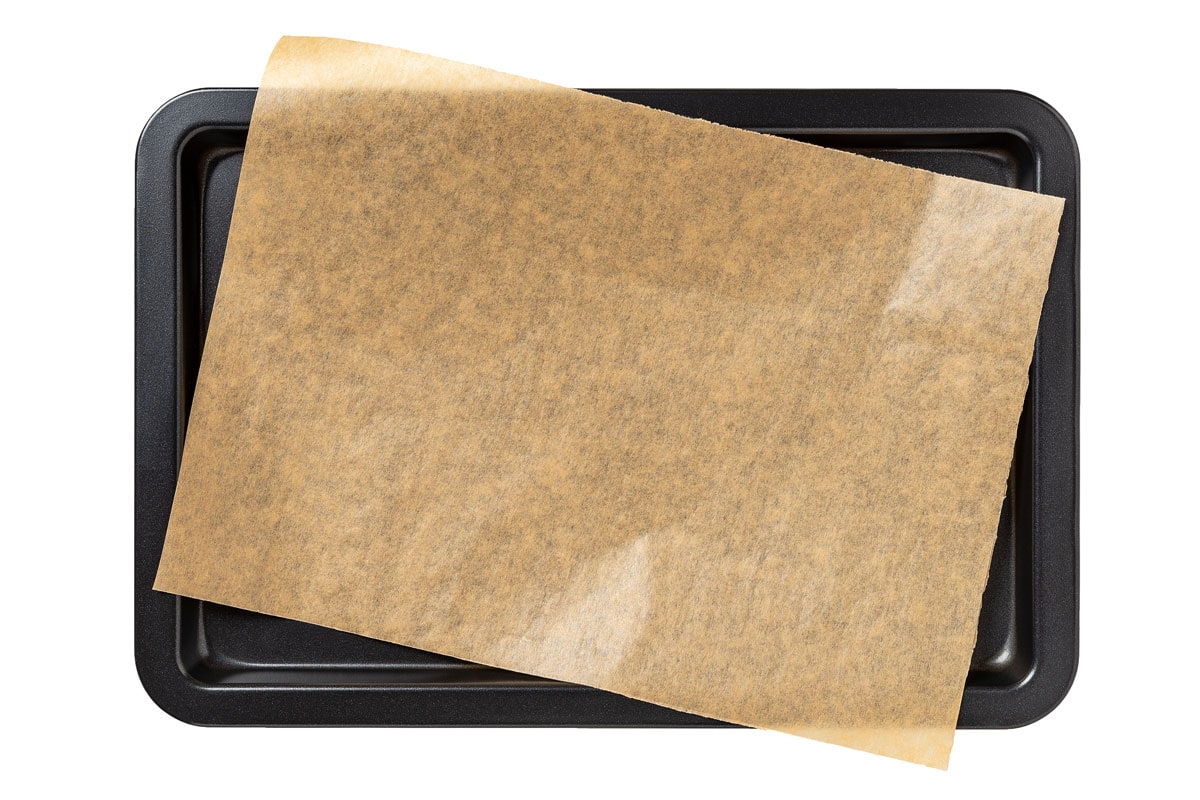 A black baking pan with parchment paper