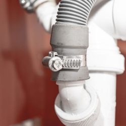A hose lock attached to a drain hose, How To Unclog A Dishwasher Drain Hose