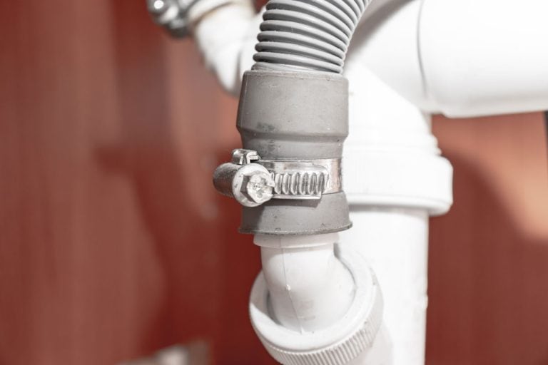 A hose lock attached to a drain hose, How To Unclog A Dishwasher Drain Hose