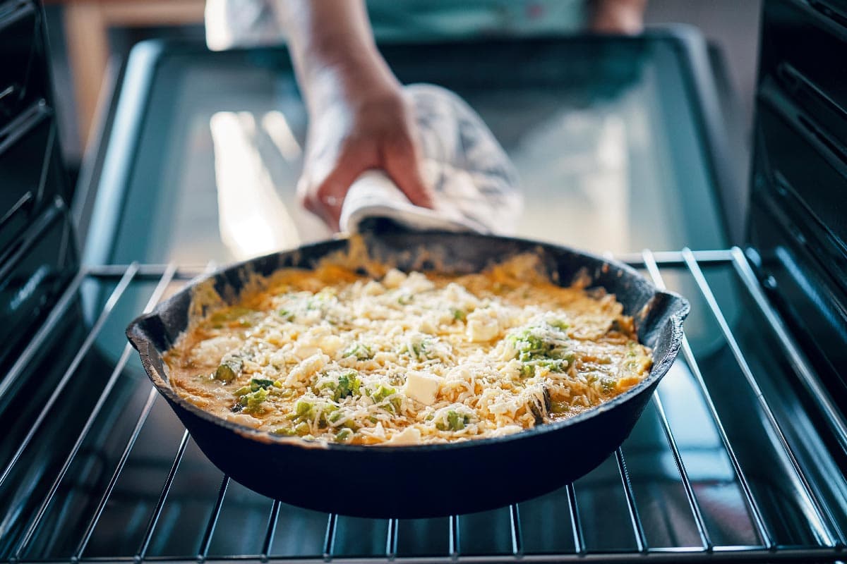 Cooking frittata with a green asparagus and parmesan on the oven, Are Pans Oven-Safe? [Even With Silicone Handles]