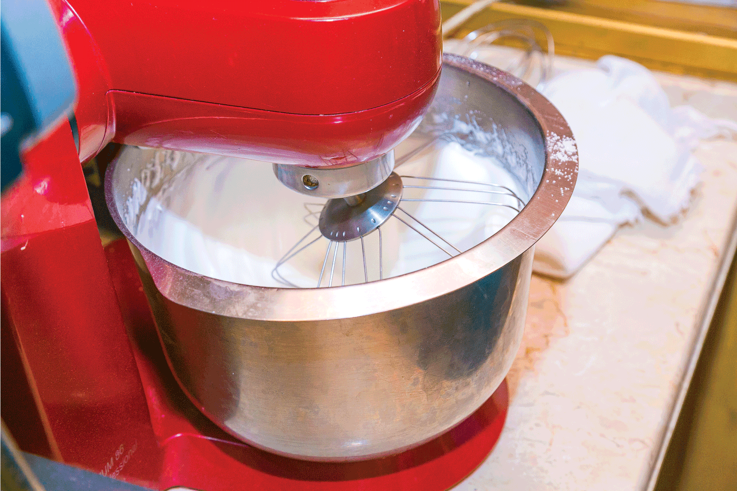 Electric mixer beats egg in the kitchen