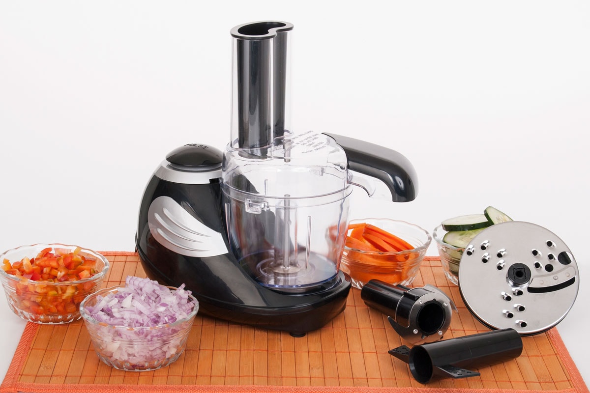Food processor with accessories and the ingredients for cooking