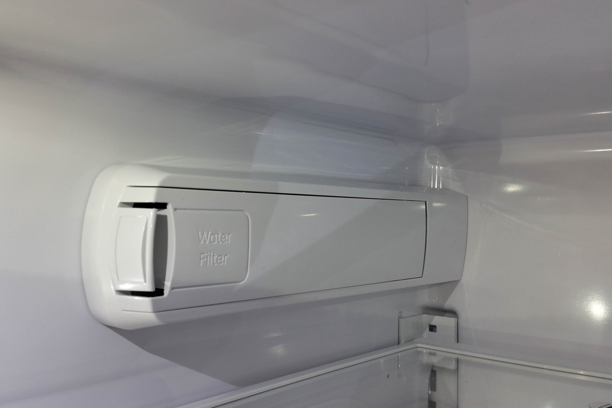 Water filter enclosure inside a refrigerator