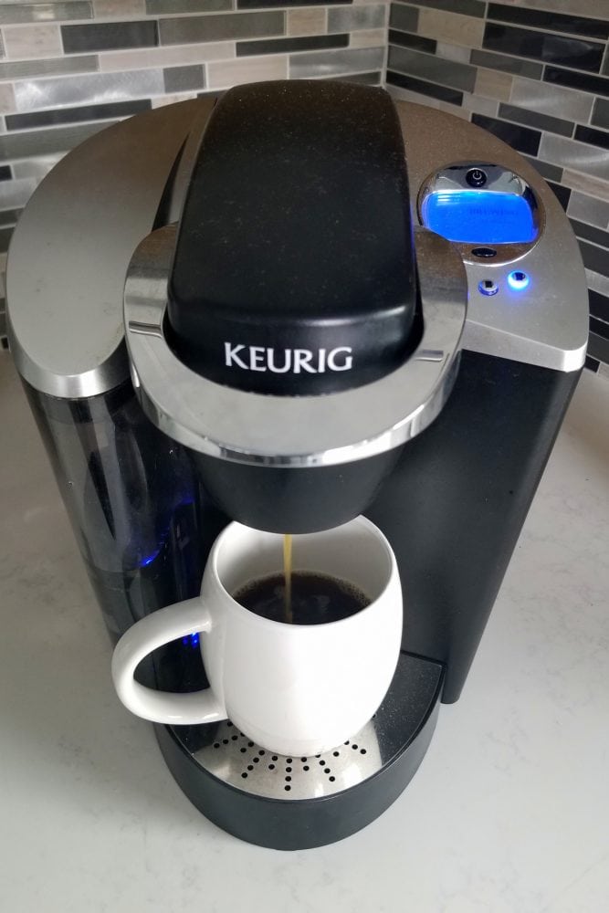  A Keurig coffee maker with a white mug