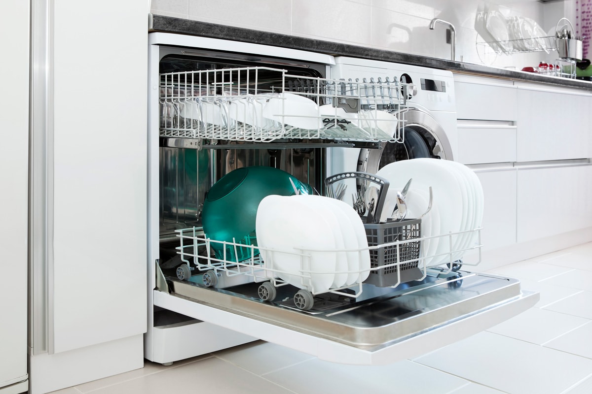 A dishwasher left opened inside a kitchen