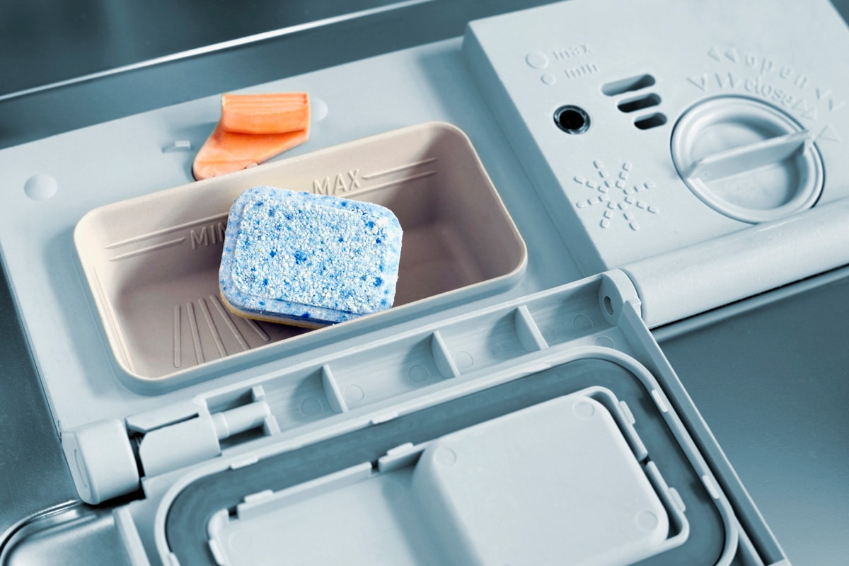 Adding detergent to the dishwasher