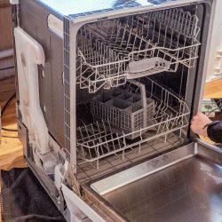 An engineer opens up a broken dishwasher to mend it and maybe remove it, How To Remove An Old KitchenAid Dishwasher