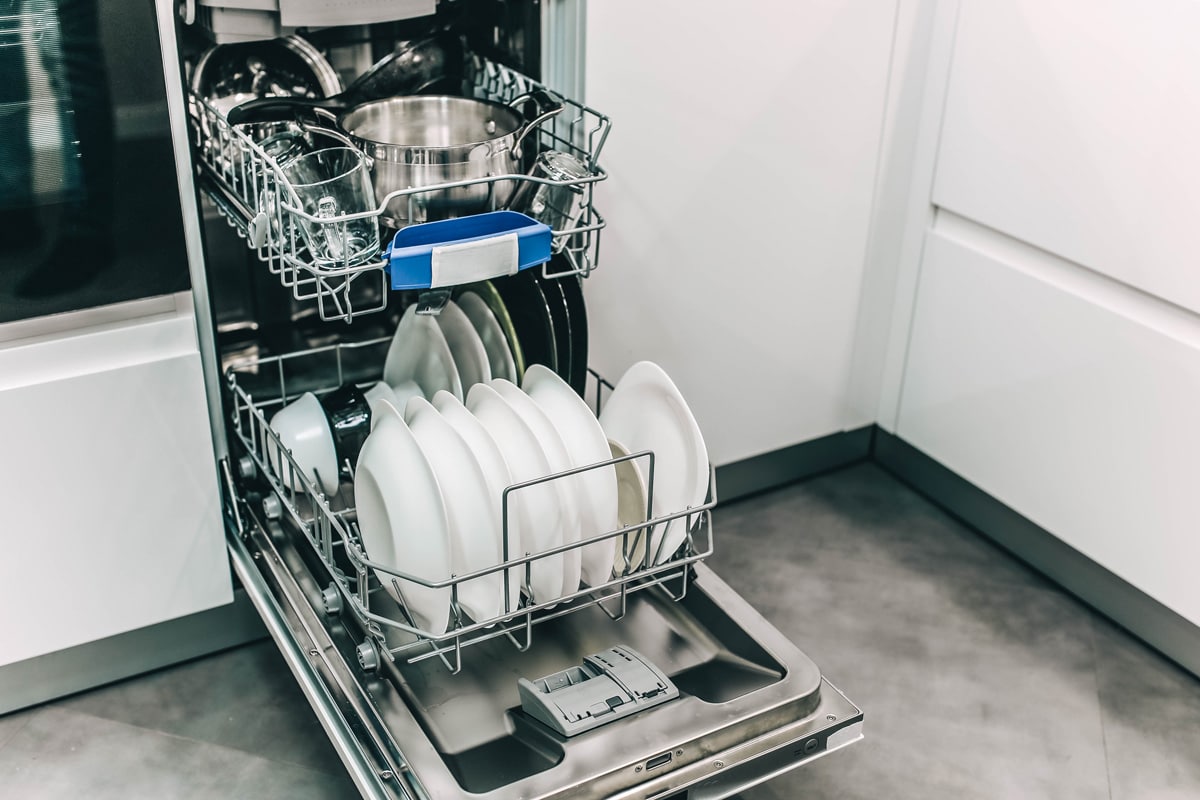 An opened dishwasher in the kitchen
