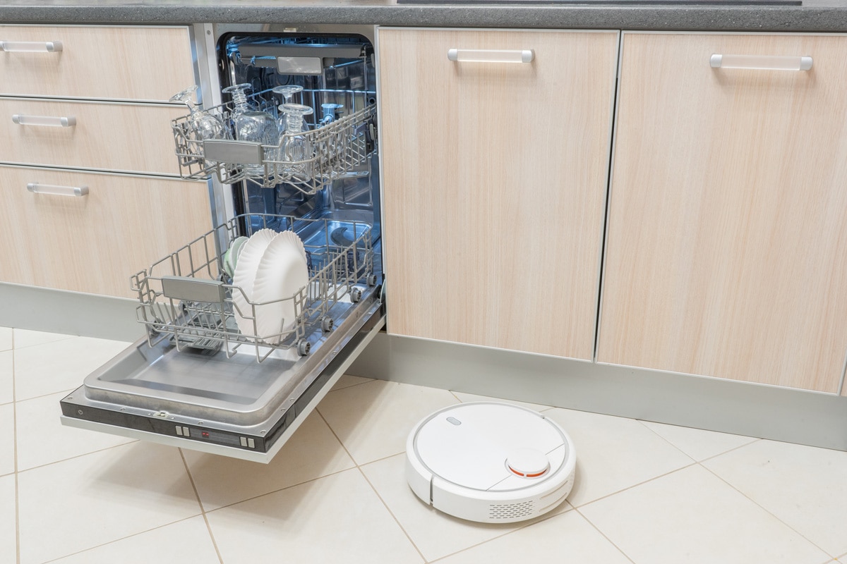 An opened dishwasher inside a white modern dishwasher