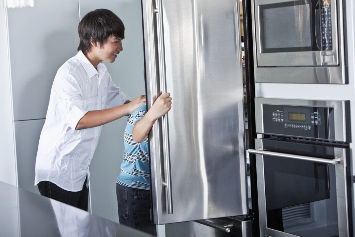 Boys looking in refrigerator