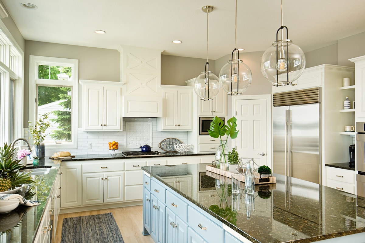 Classic designed kitchen with white painted cabinets and black countertop to match the overall design of the kitchen