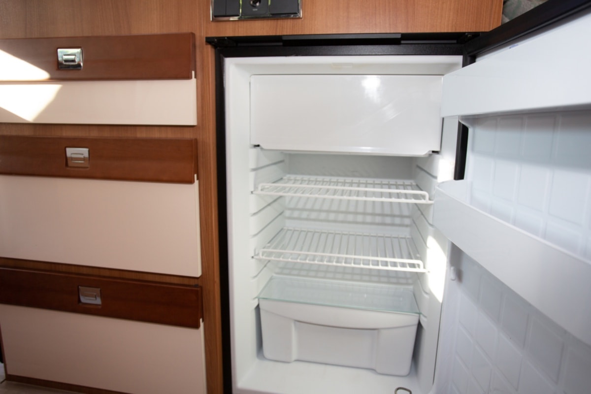 Cleaning The Plastic Liner -open empty fridge in camper van