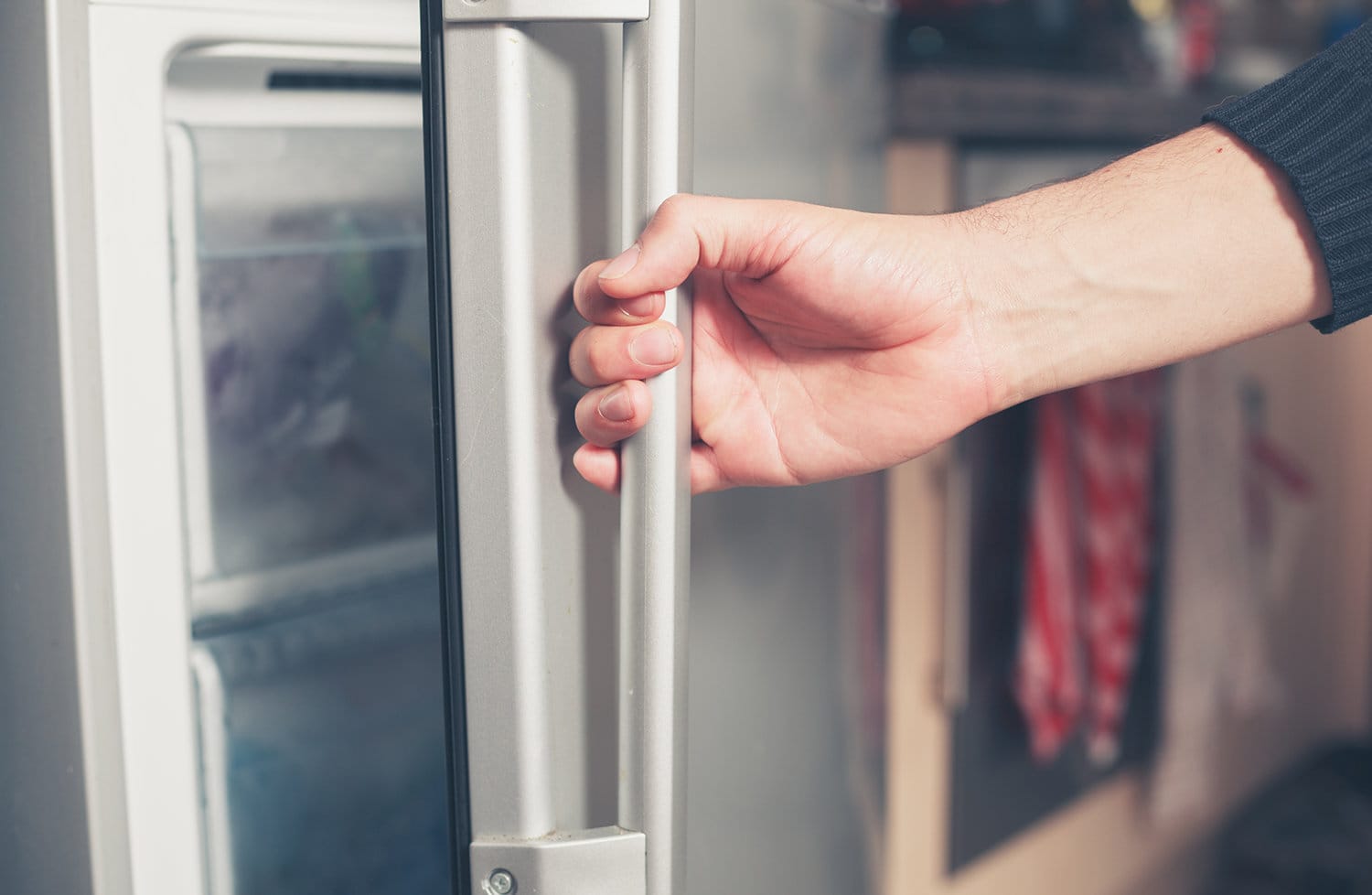 Man opening a freezer door