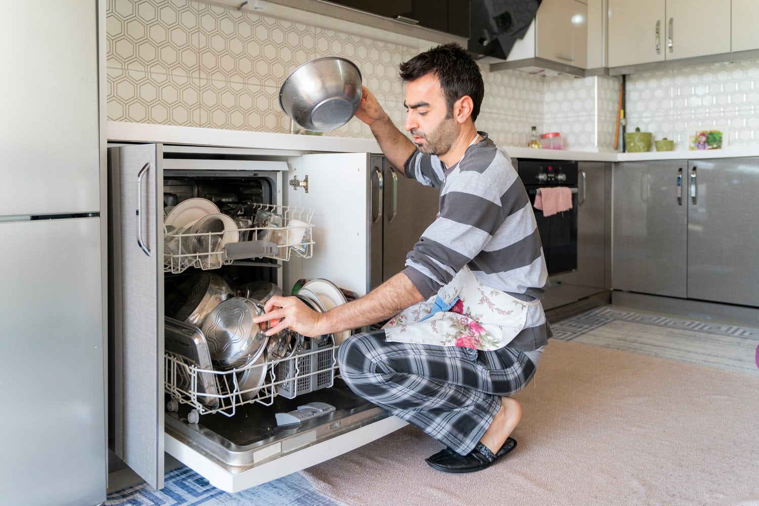 Man operating dishwasher