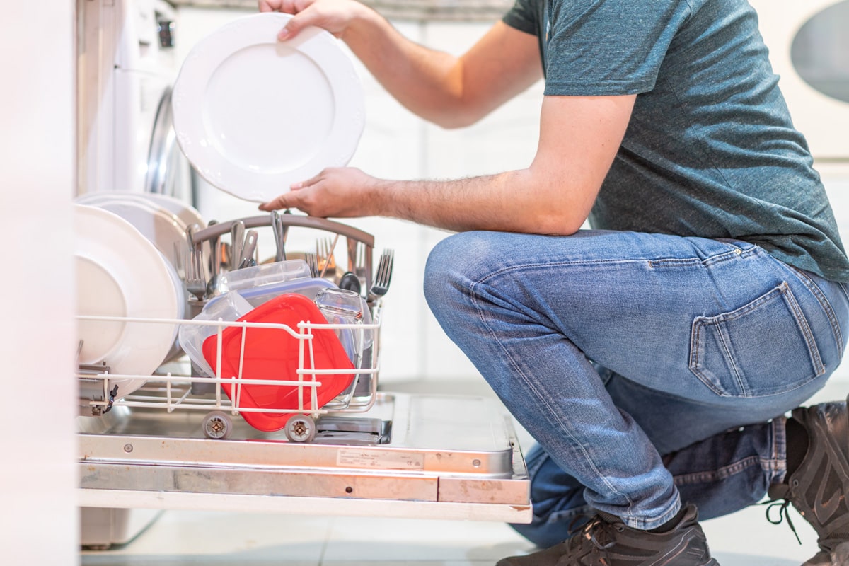 Man putting dishes in the bosch dishwasher