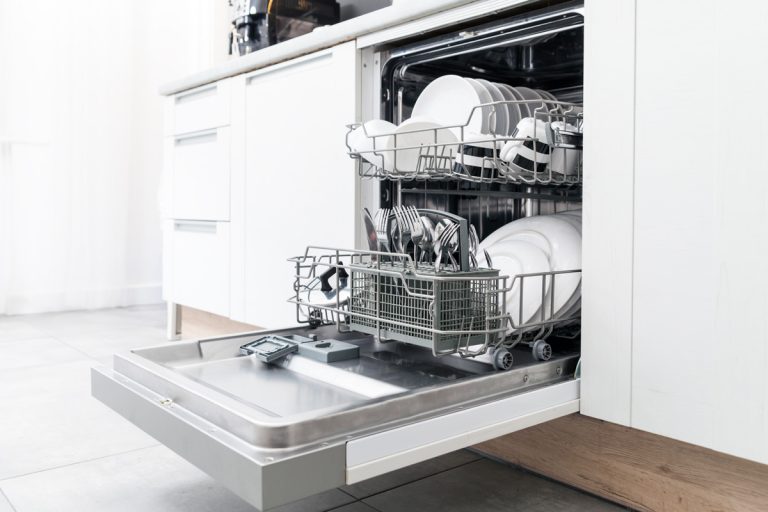 Open dishwasher with clean dishes in the white kitchen, Kitchenaid Dishwasher Not Getting Or Filling With Water—What To Do?