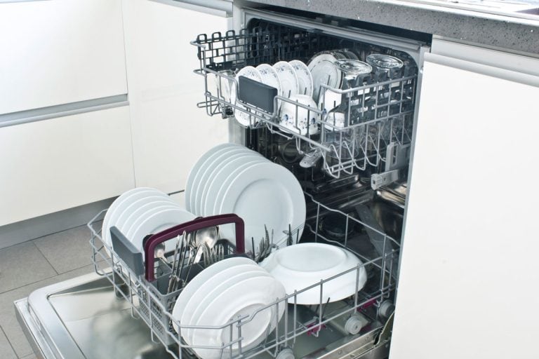 Open dishwasher with clean dishes in the white kitchen, How To Attach Drain Hose To Dishwasher