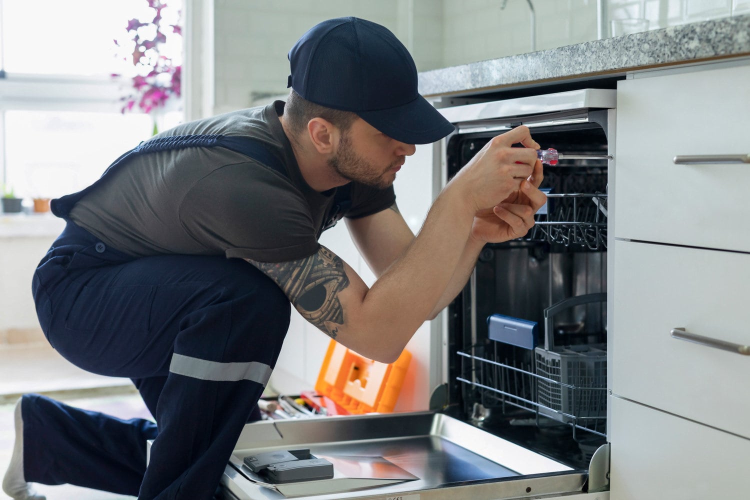 Technician examining dishwasher
