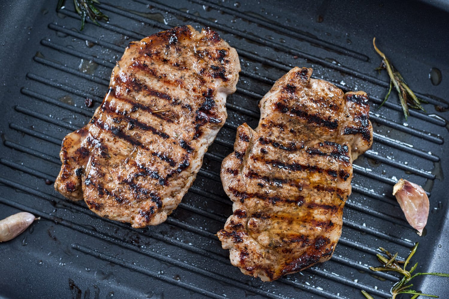 Two Grilled Steaks On a Grill Pan. 