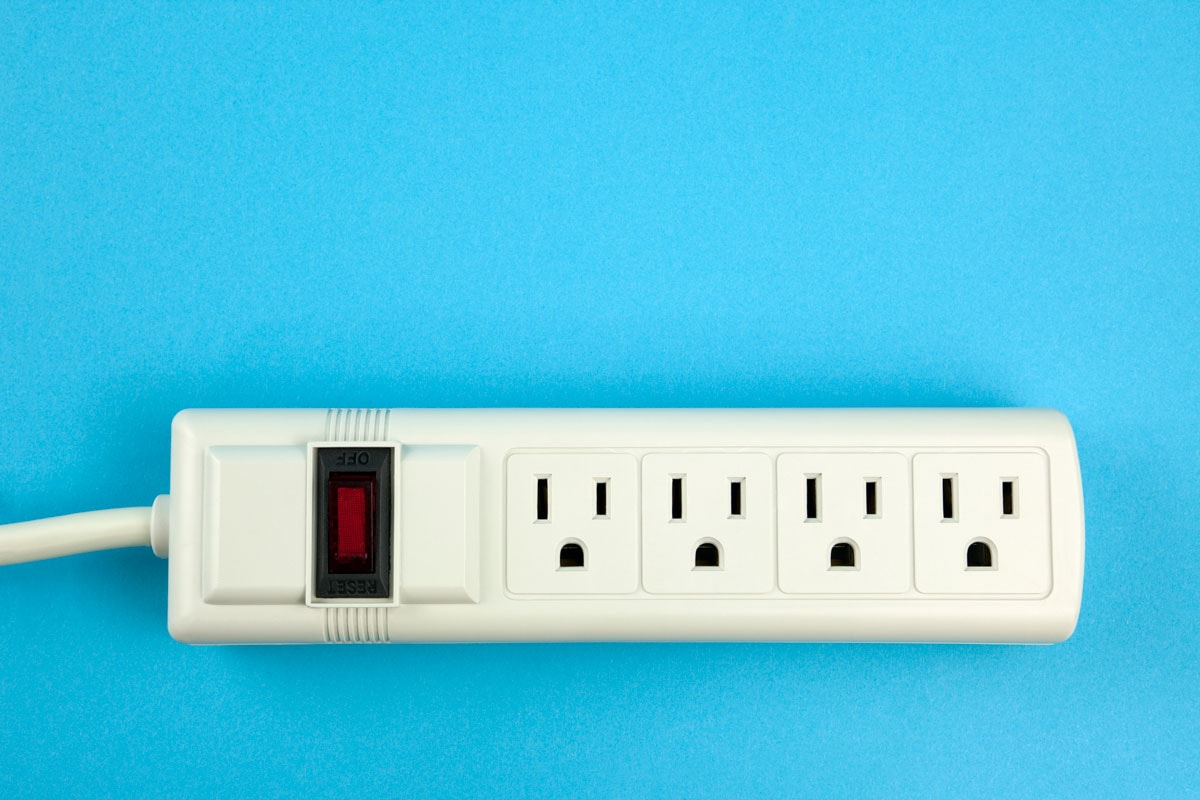 a white Electrical power strip on a blue background