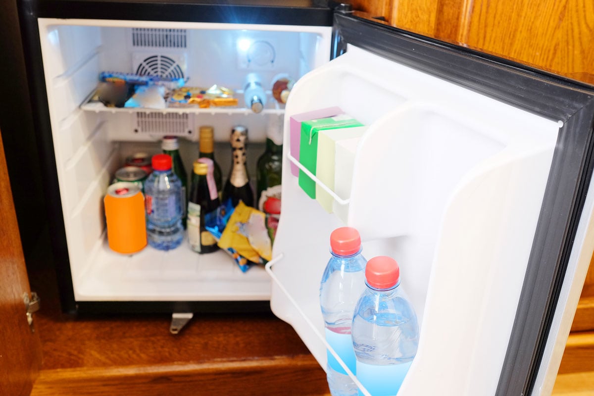 photo of a black mini refrigerator with many things stuffs inside drinks