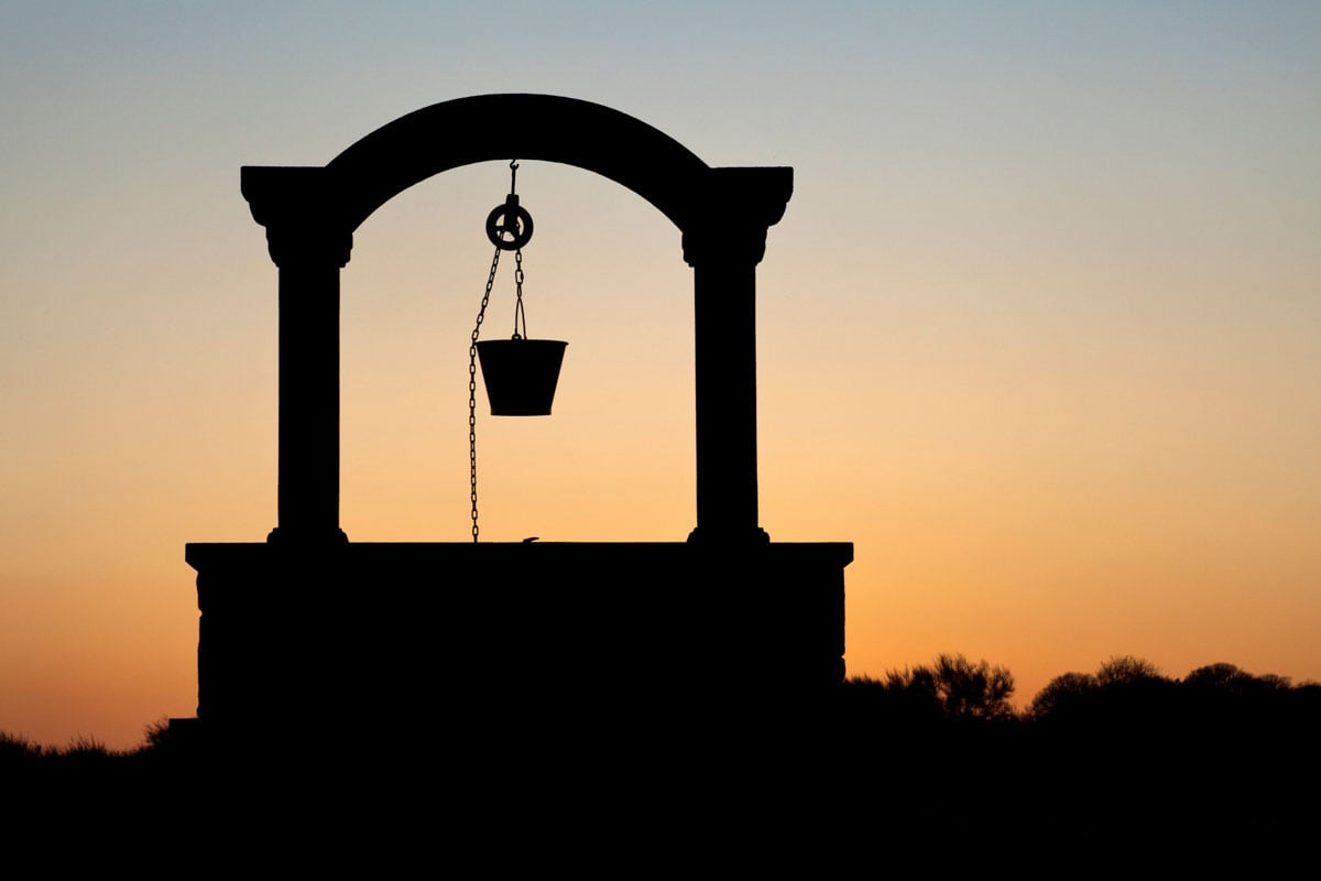 silhouette of a well at sunset