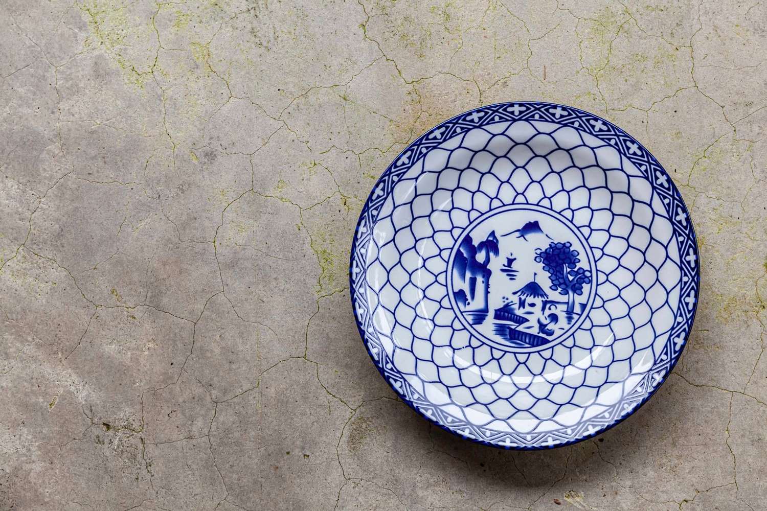 Blue and white patterned plates on the stone table