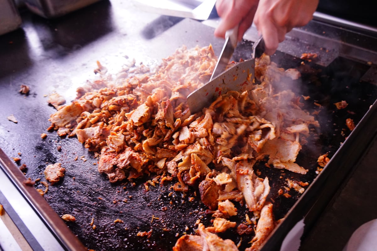 Chef making Mexican food in a griddle