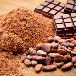 Cocoa Beans and Cocoa Powder with Chocolate Bars on Wood Table - Can I Grind Cocoa Beans In A Coffee Grinder