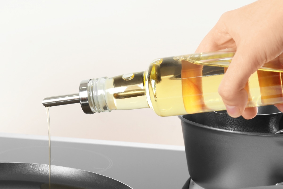 Cooking oil from bottle into frying pan