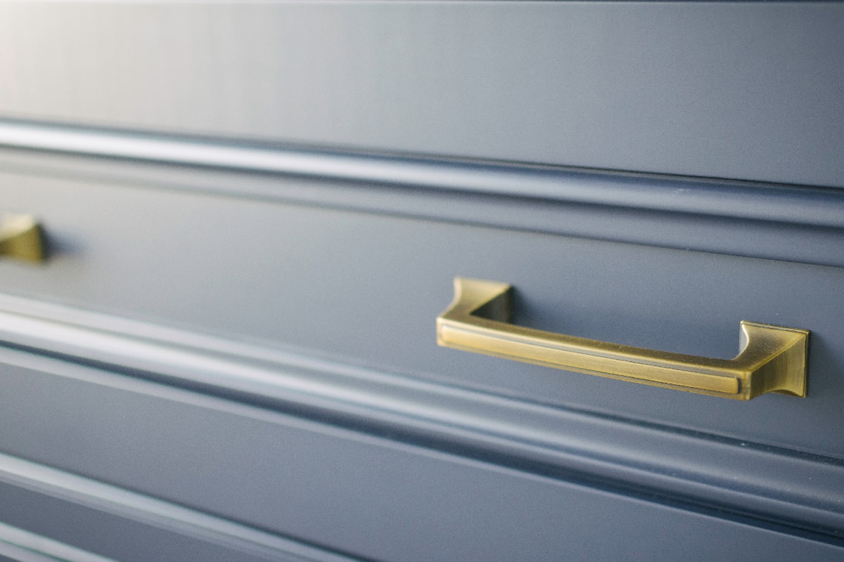Gold hardware on blue cabinets