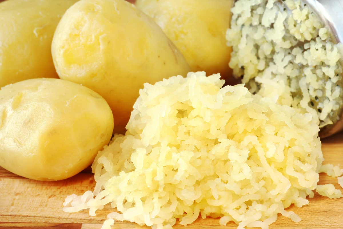Mashed potatoes processed through a ricer for the preparation of gnocchi with peeled potatoes
