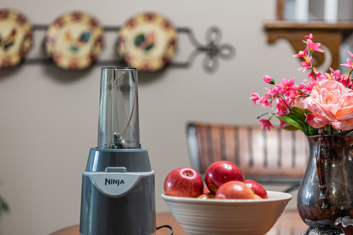 Ninja Juicer with bowl of apples on a table
