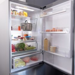 Open refrigerator filled with fresh fruits and vegetable