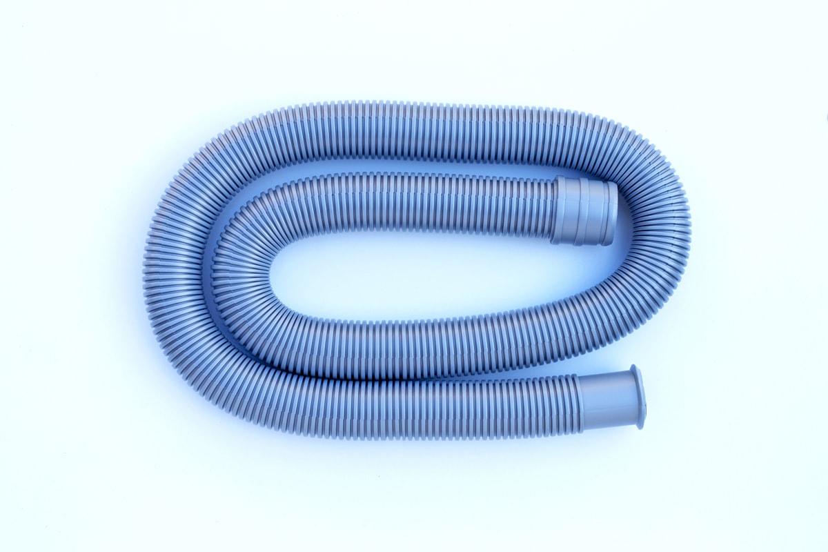 Plastic drain pipe on white background.
