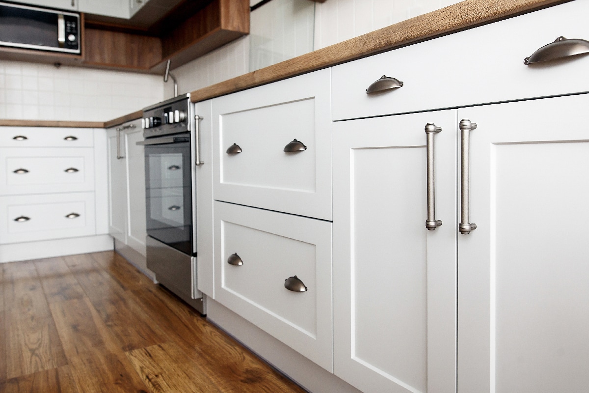 Stylish light gray handles on cabinets
