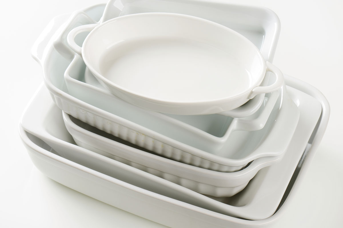 Variety of baking dishes white colored old corningware on a white background