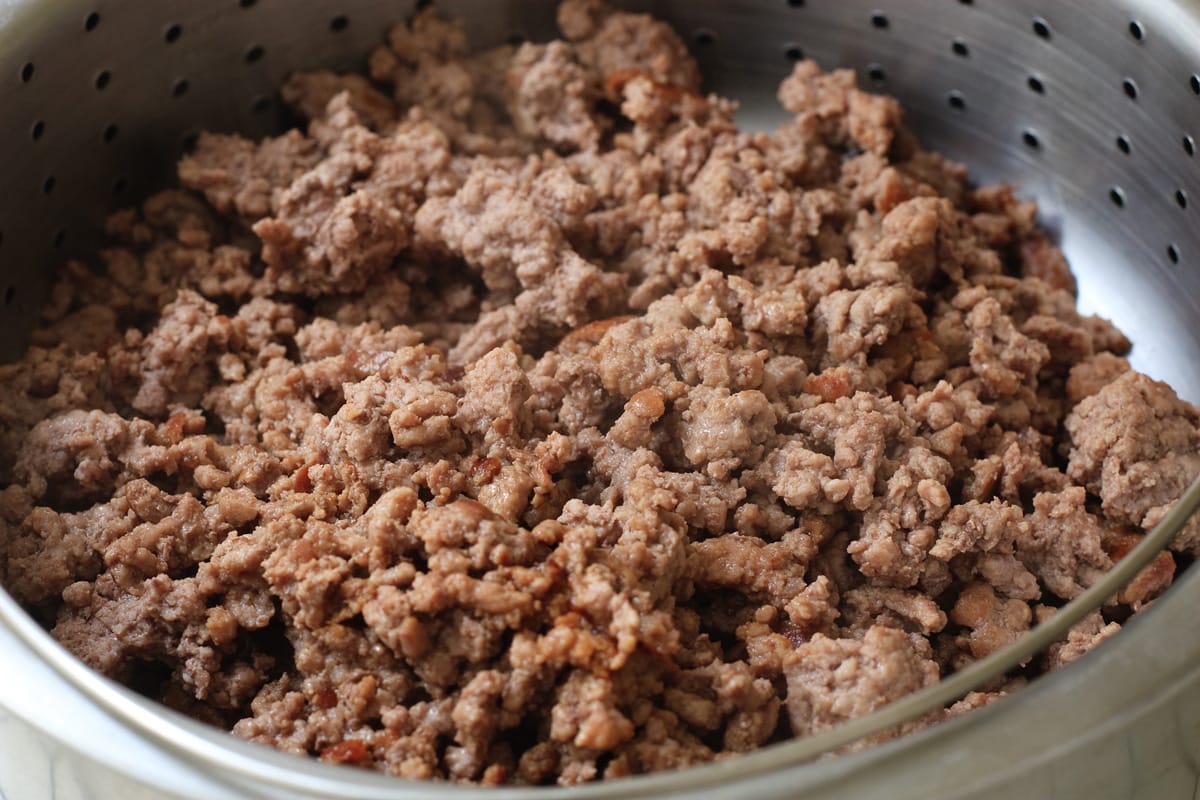 cooked ground beef in a strainer