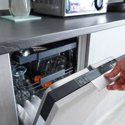 photo of a man opening and closing the dishwasher. Washing dishes in the dishwasher. The man cares about the house, does his homework, LG Dishwasher Touch Panel Not Working - What To Do?