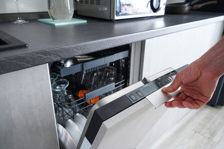 photo of a man opening and closing the dishwasher. Washing dishes in the dishwasher. The man cares about the house, does his homework, LG Dishwasher Touch Panel Not Working - What To Do?